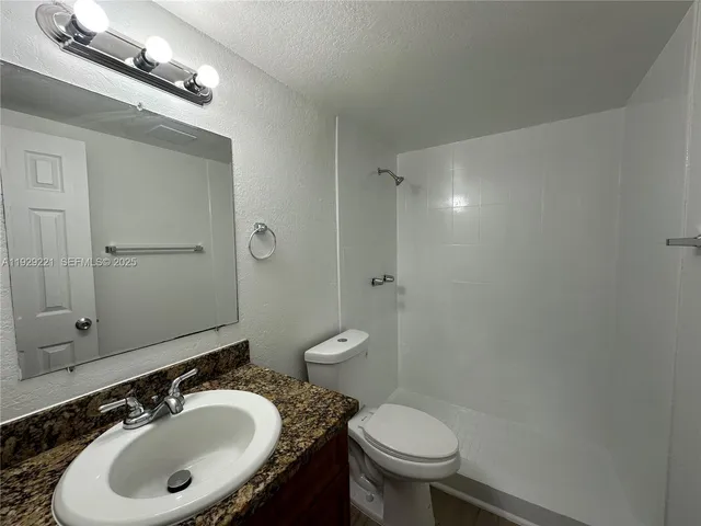 a bathroom with a sink toilet a mirror and vanity