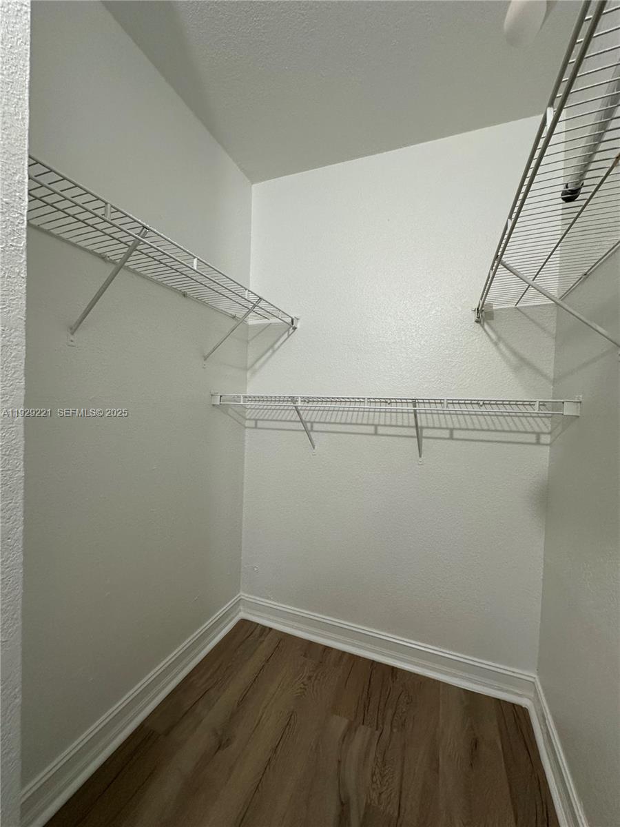 1400 Northeast 56th Street, Unit 105 Fort Lauderdale, FL 33334 - Photo 29 of 42 a view of a room with racks on the wall