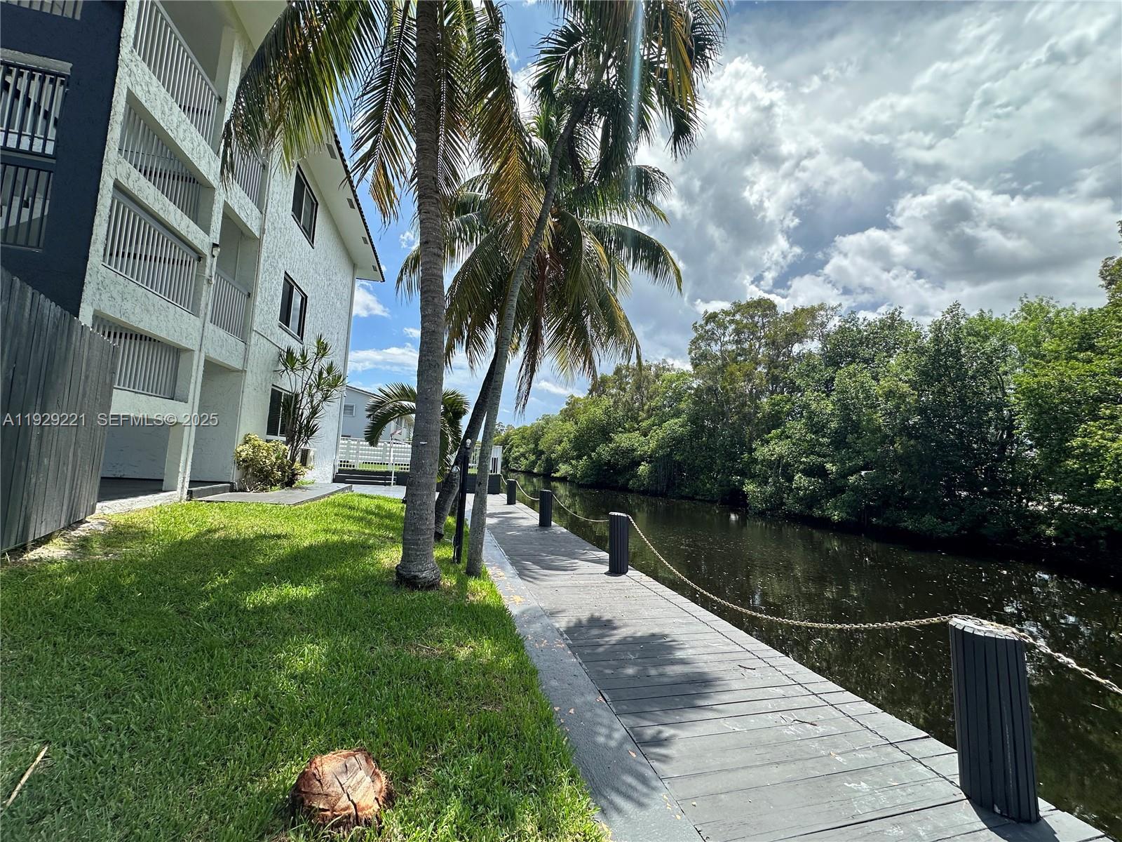 1400 Northeast 56th Street, Unit 105 Fort Lauderdale, FL 33334 - Photo 37 of 42 a lake view with a garden