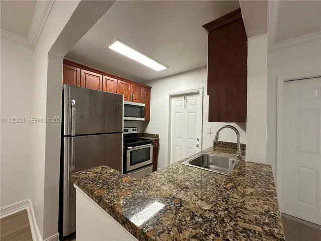 a kitchen with a refrigerator sink and stove