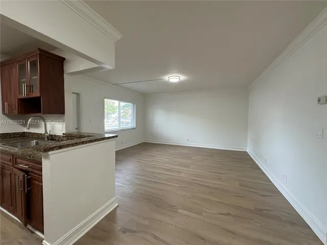 a kitchen with granite countertop a stove and a sink