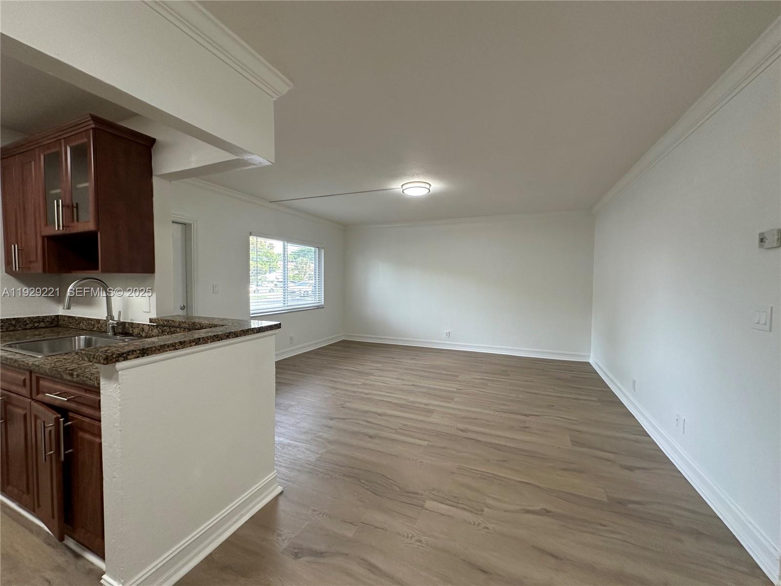 1400 Northeast 56th Street, Unit 105 Fort Lauderdale, FL 33334 - Photo 5 of 42 a kitchen with granite countertop a stove and a sink
