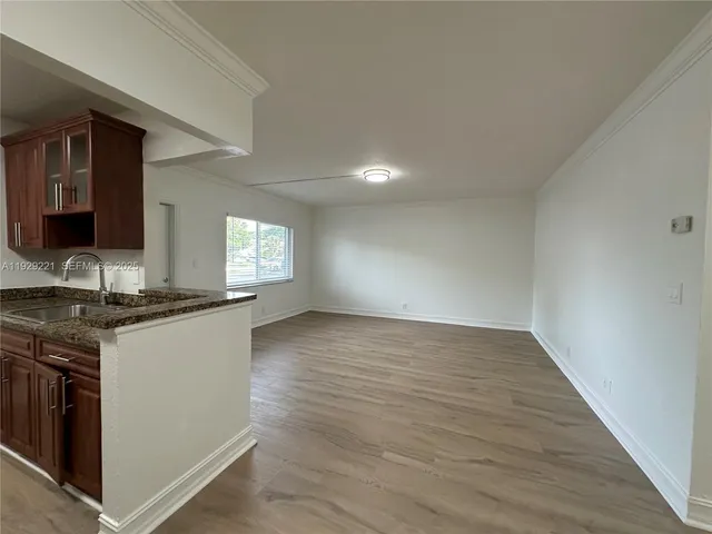 a kitchen with granite countertop a stove and a sink