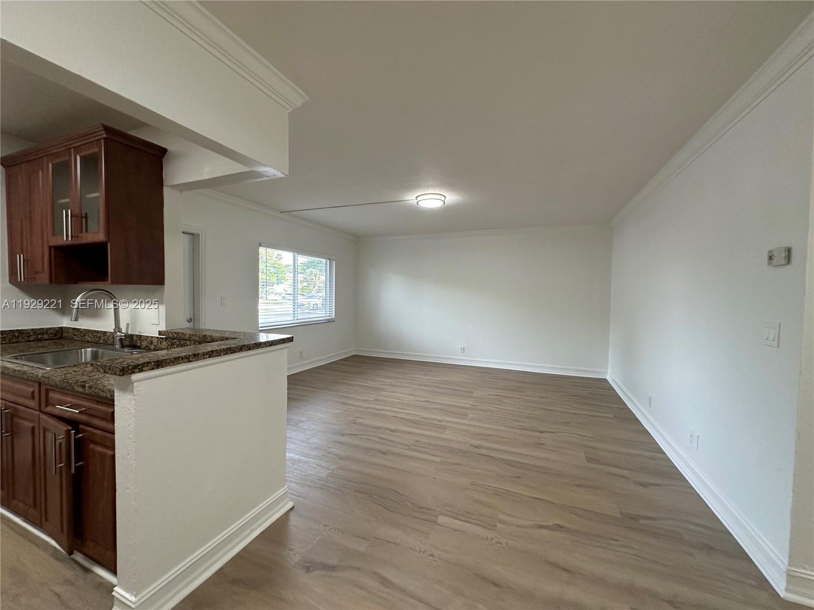 1400 Northeast 56th Street, Unit 105 Fort Lauderdale, FL 33334 - Photo 6 of 42 a kitchen with granite countertop a stove and a sink