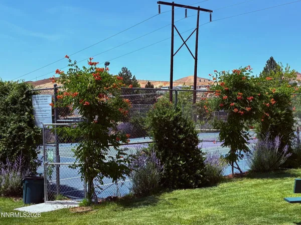 a view of a house with a yard and potted plants