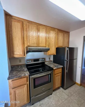 a kitchen with a stove and a refrigerator