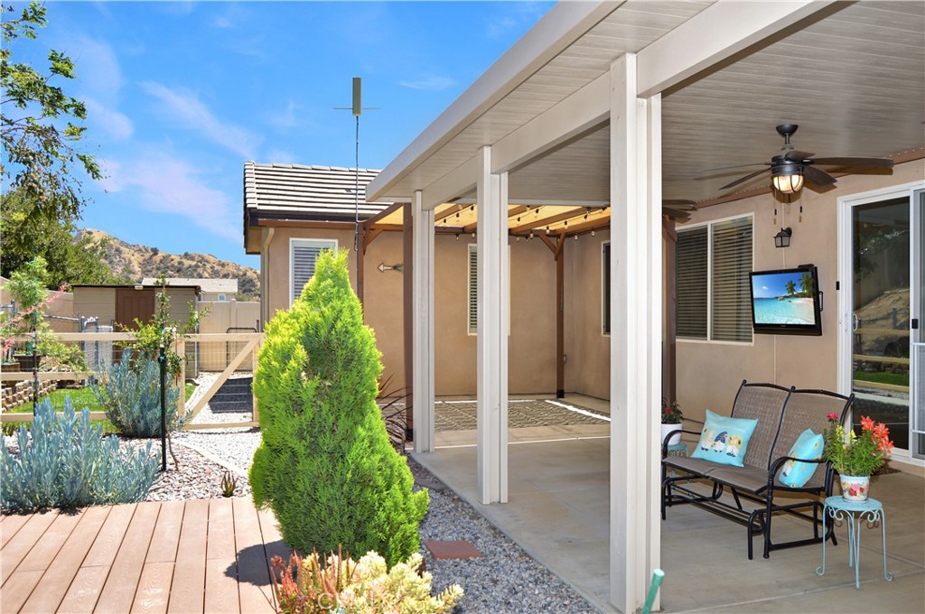 166 Fox Lane Calimesa, CA 92320 - Photo 67 of 76 Enjoy the View of Your Very Own Fruit Trees from the Covered Patio with Ceiling Fans and TV Included (Screen simulated)
