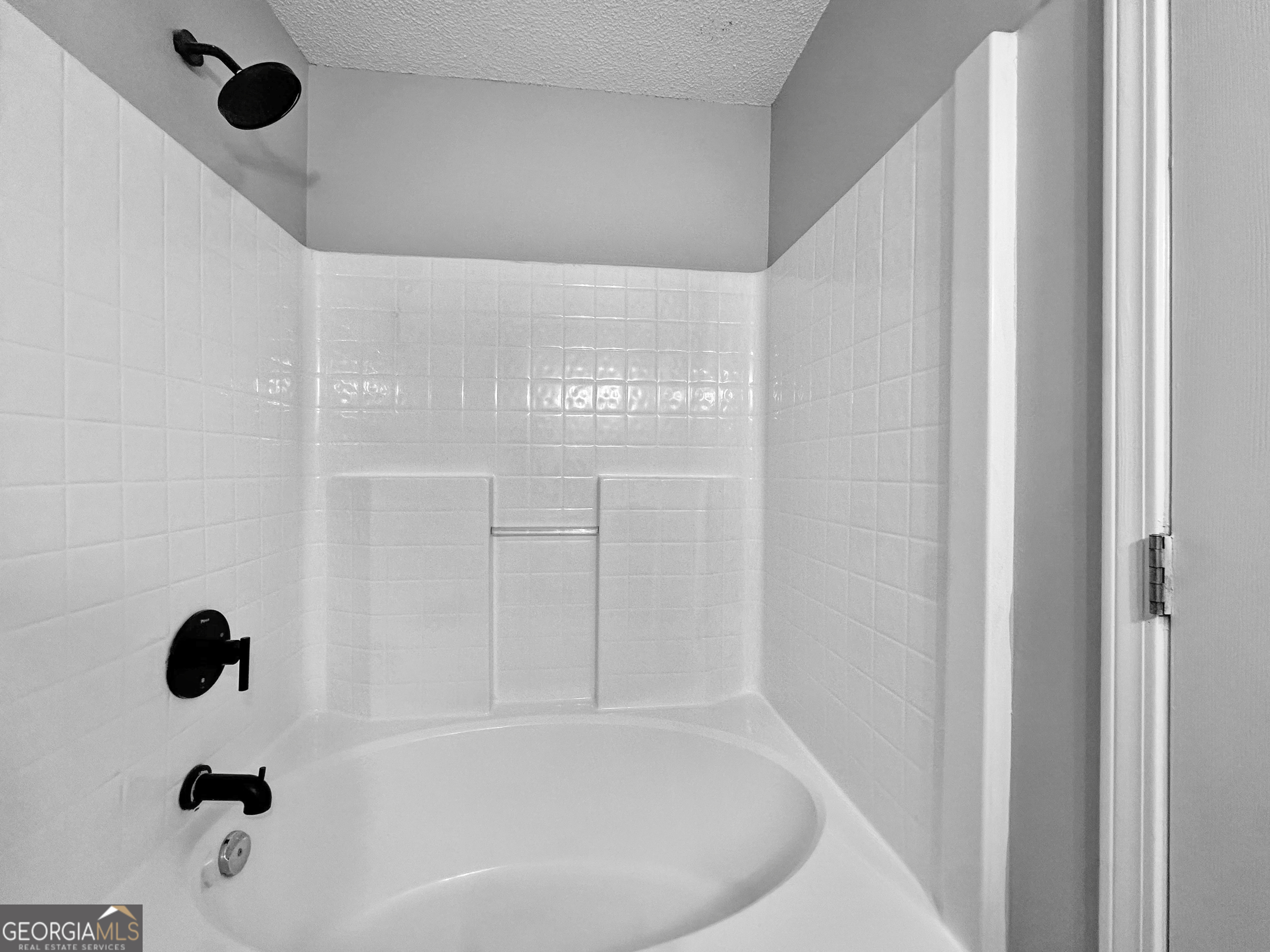 368 Wesley Mill Place Villa Rica, GA 30180 - Photo 12 of 18 a bathroom with a bathtub and shower