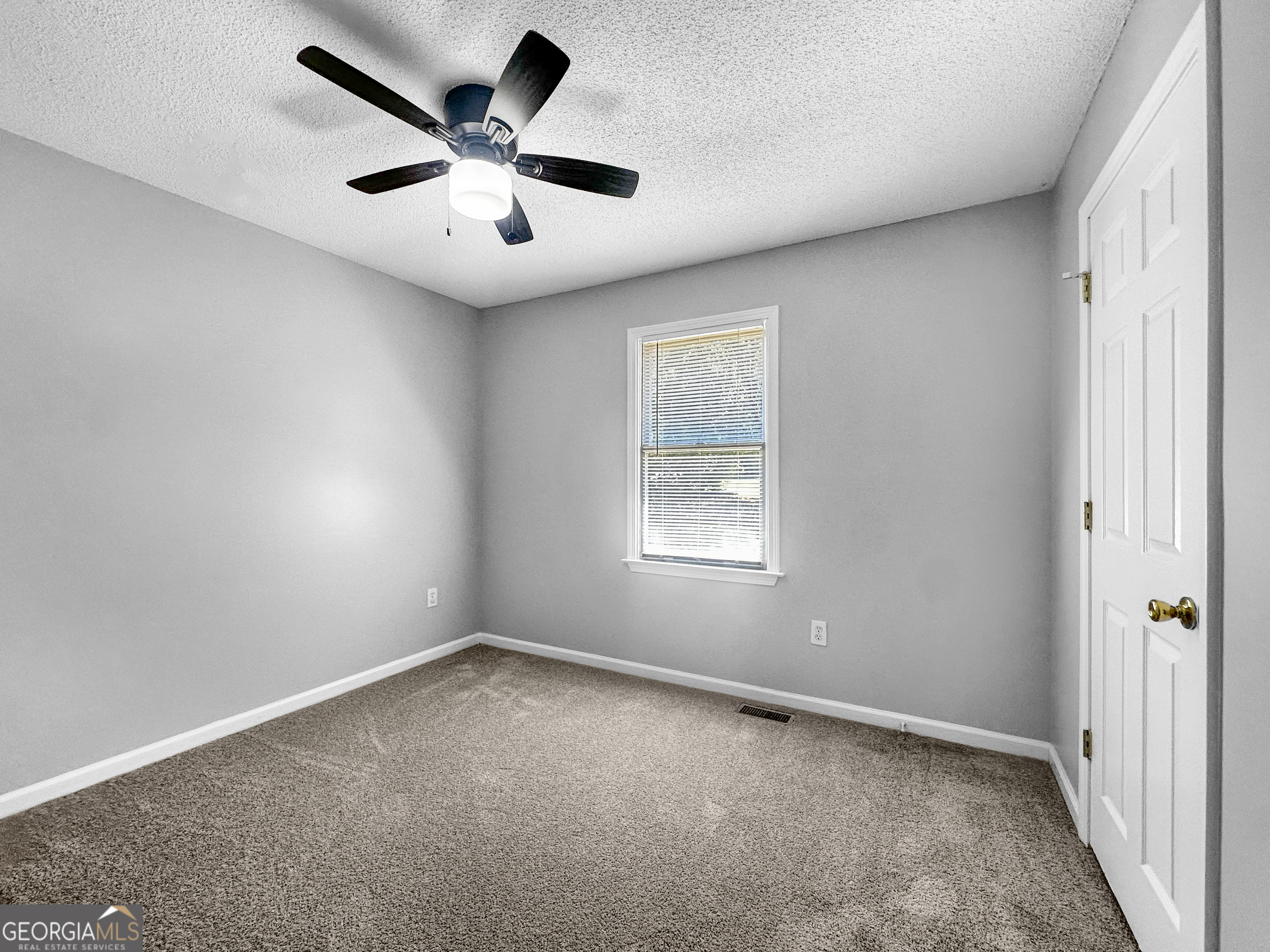 368 Wesley Mill Place Villa Rica, GA 30180 - Photo 14 of 18 an empty room with ceiling fan and windows