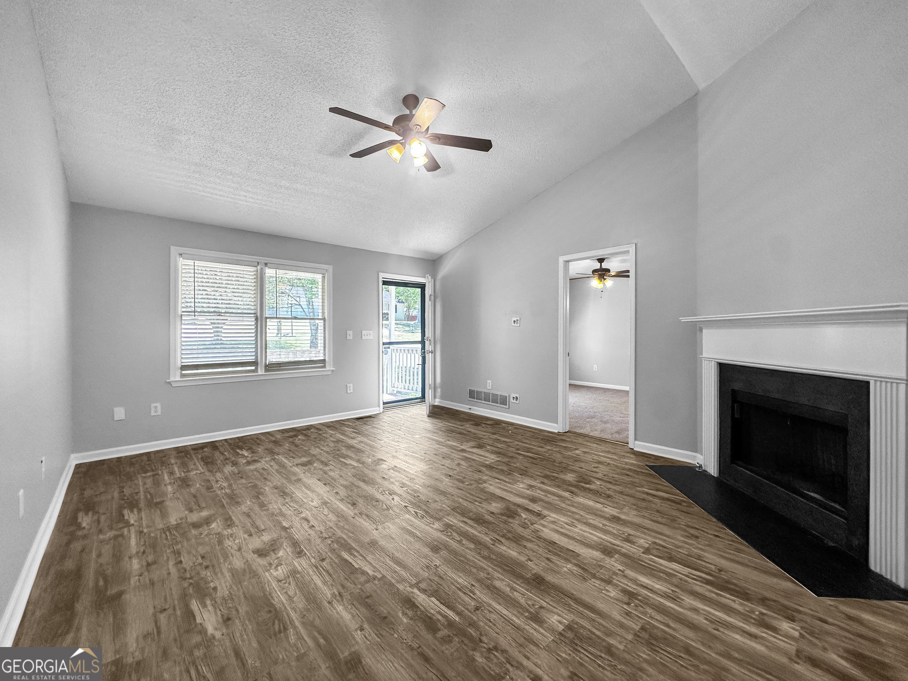 368 Wesley Mill Place Villa Rica, GA 30180 - Photo 5 of 18 a view of empty room with wooden floor and fireplace
