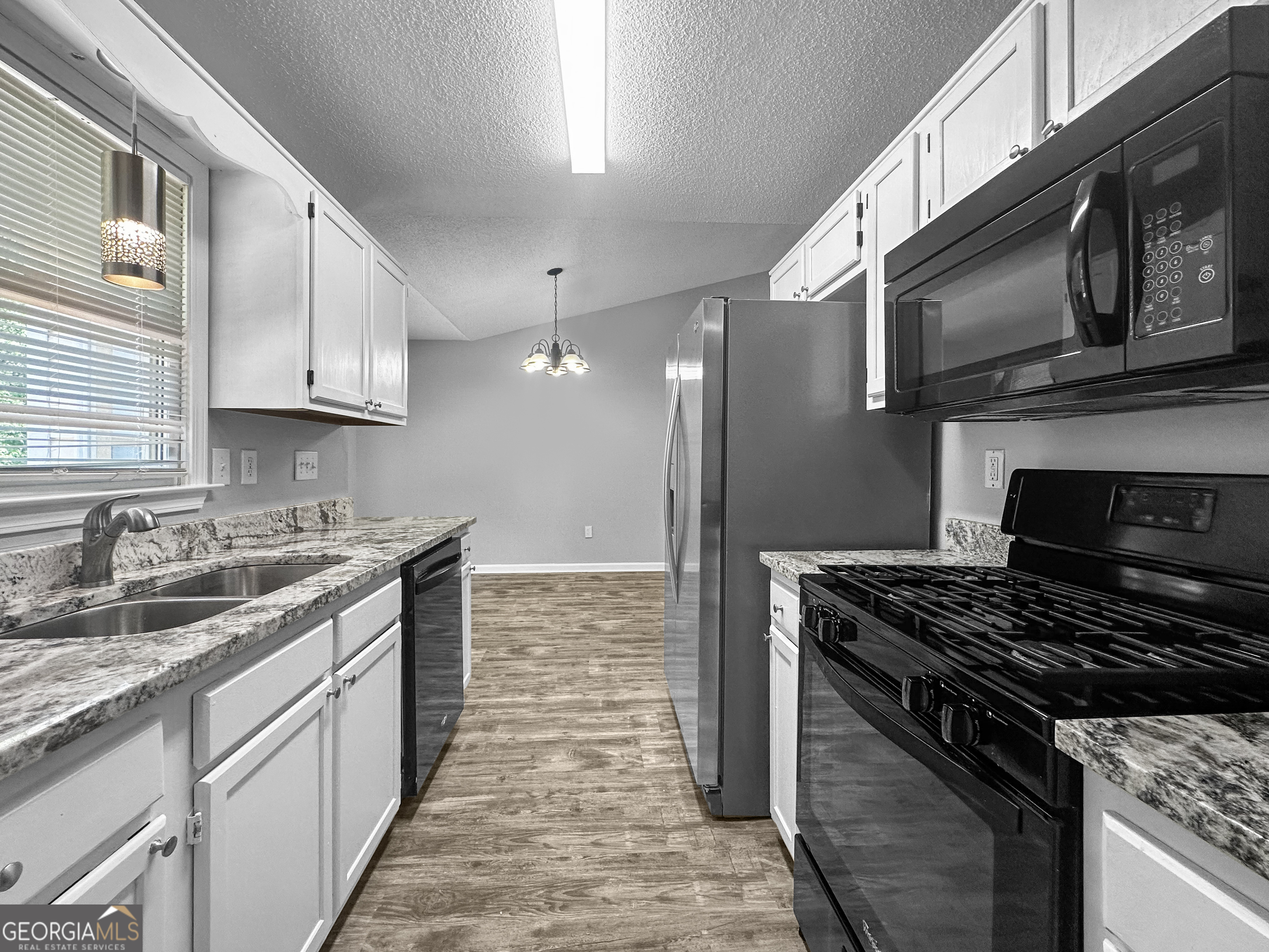 368 Wesley Mill Place Villa Rica, GA 30180 - Photo 7 of 18 a kitchen with stainless steel appliances granite countertop a stove and a sink