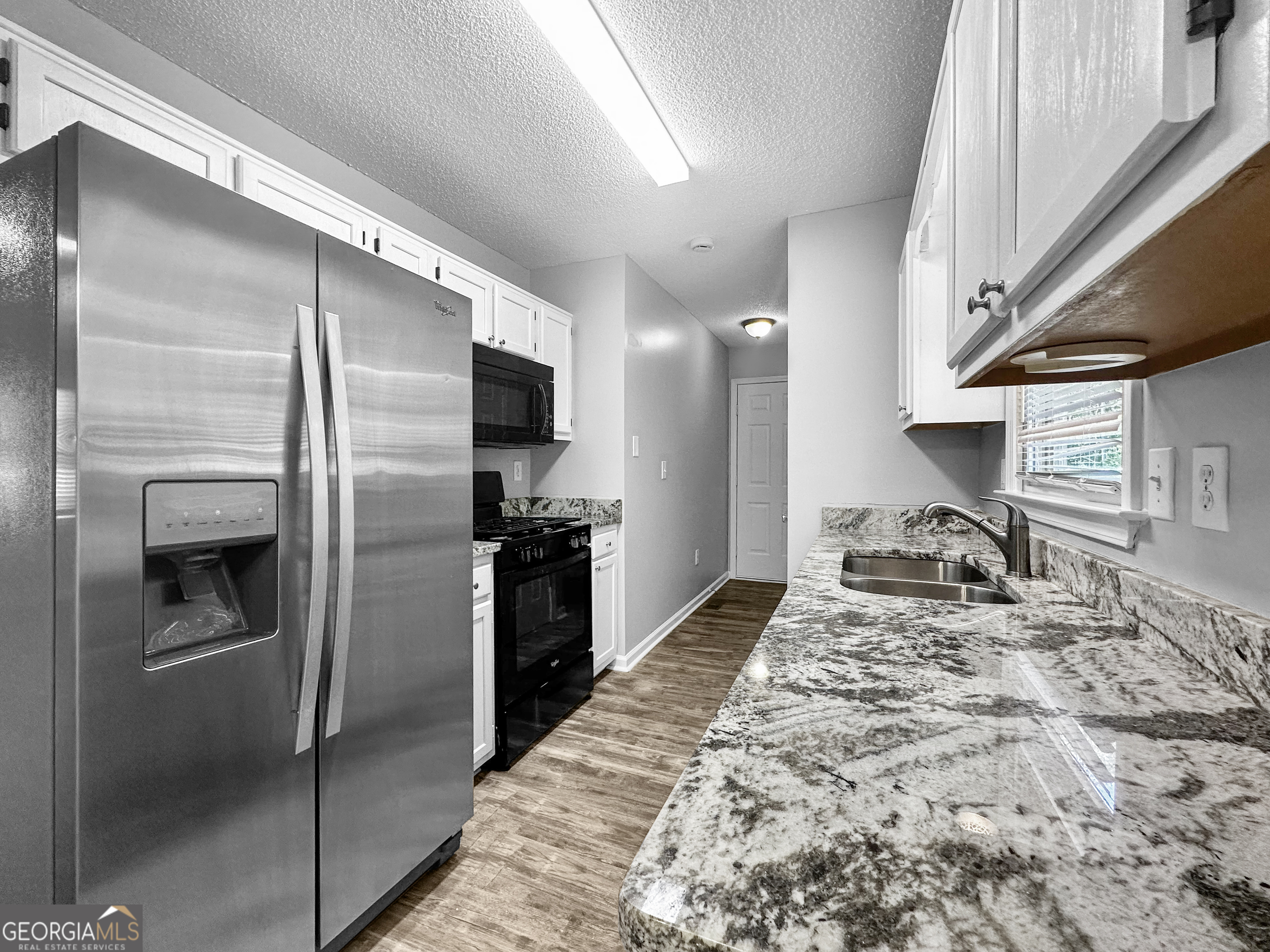 368 Wesley Mill Place Villa Rica, GA 30180 - Photo 8 of 18 a kitchen with stainless steel appliances granite countertop a refrigerator and a sink