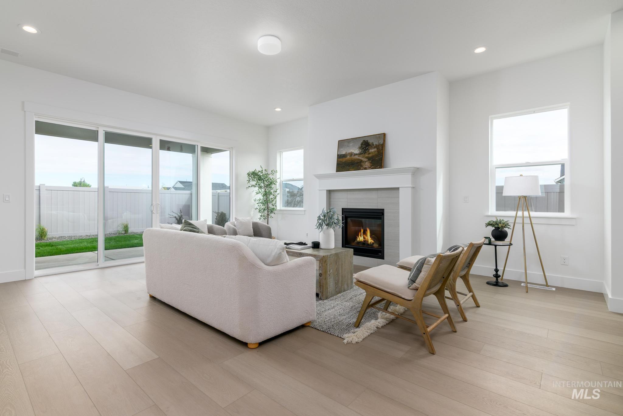 8555 West Fanning Street Star, ID 83669 - Photo 2 of 11 Living room with recessed lighting, light wood finished floors, and a glass covered fireplace