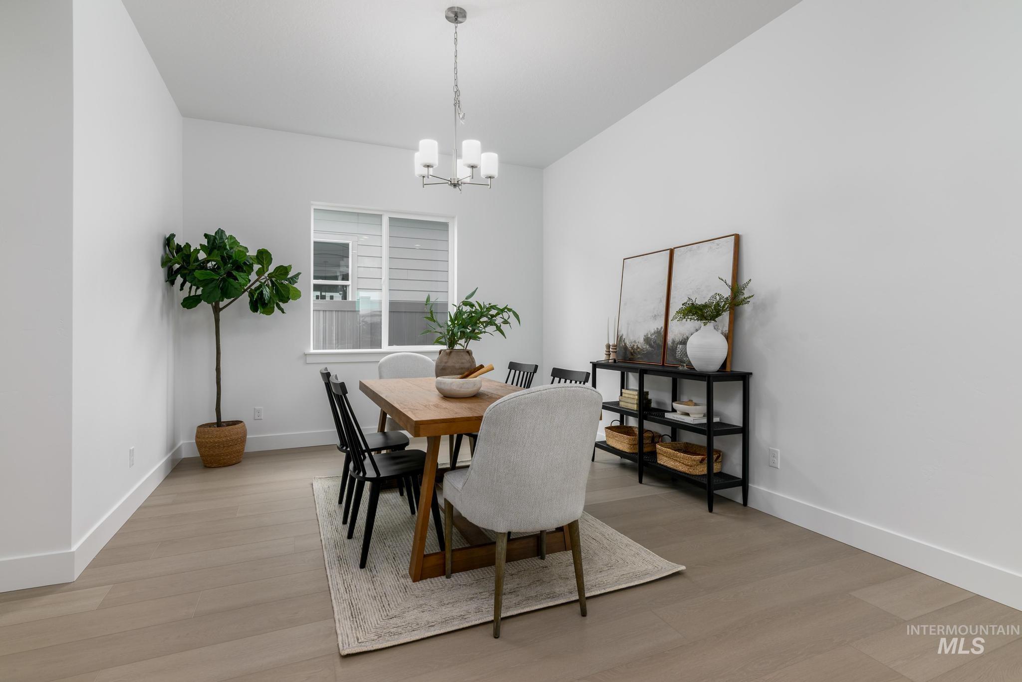 8555 West Fanning Street Star, ID 83669 - Photo 6 of 11 Dining space with light wood-style floors and a chandelier