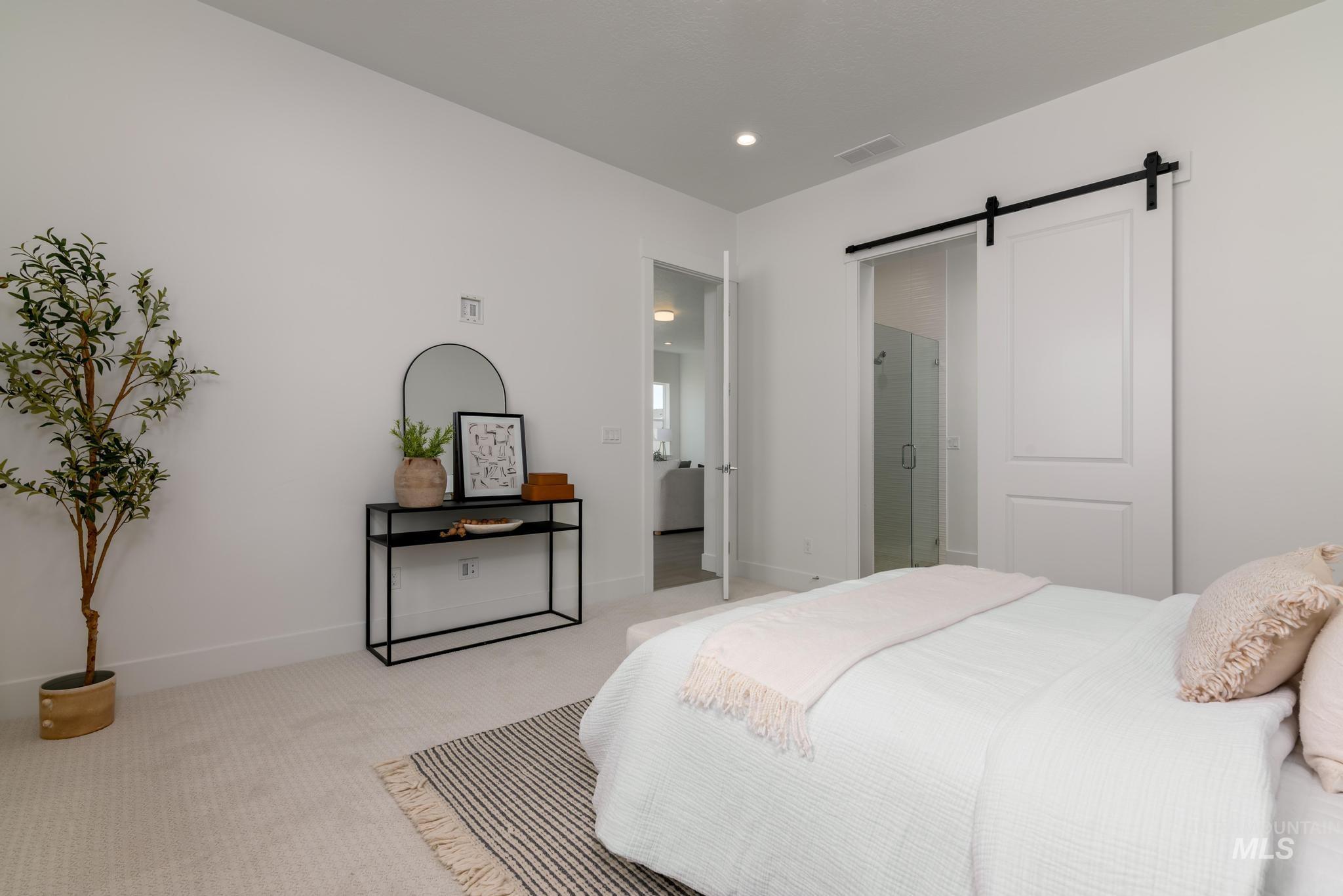 8555 West Fanning Street Star, ID 83669 - Photo 8 of 11 Carpeted bedroom with a barn door, recessed lighting, and connected bathroom