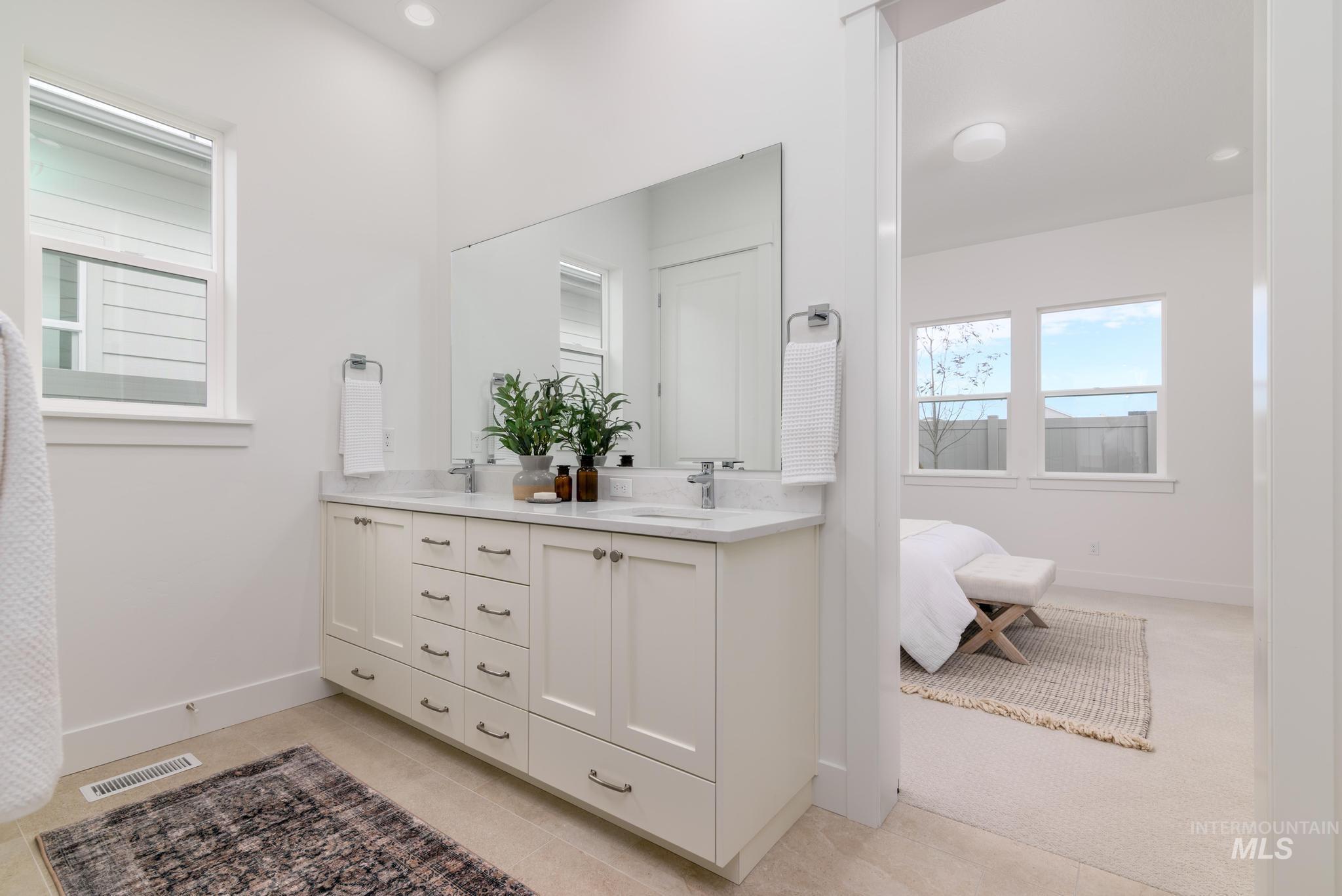 8555 West Fanning Street Star, ID 83669 - Photo 9 of 11 Full bath with double vanity, light carpet, recessed lighting, and ensuite bath