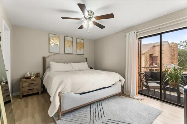 a bedroom with a bed and a large window