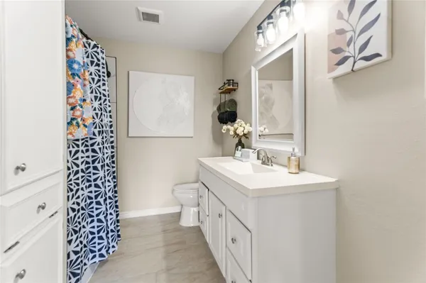 a bathroom with a double vanity sink mirror and shower