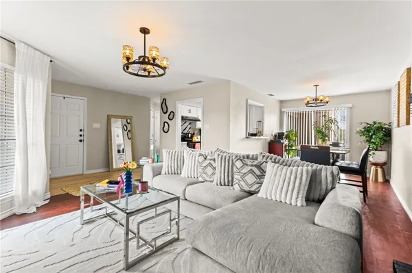 a living room with furniture and a dining table