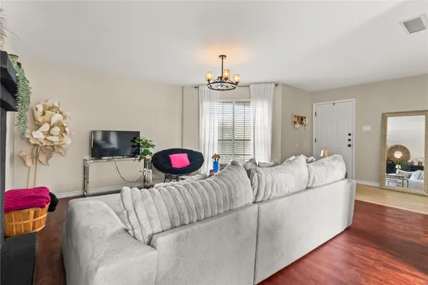 a living room with furniture and a chandelier
