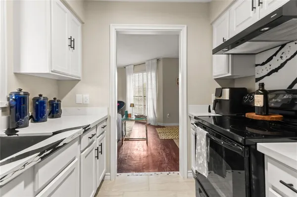 a kitchen with stainless steel appliances granite countertop a stove and a sink