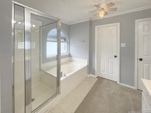 a spacious en suite bathroom with a bathtub and shower