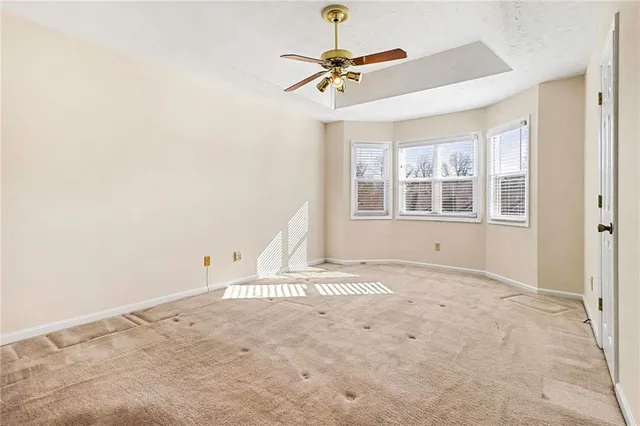 a view of a livingroom with a window and a ceiling fan