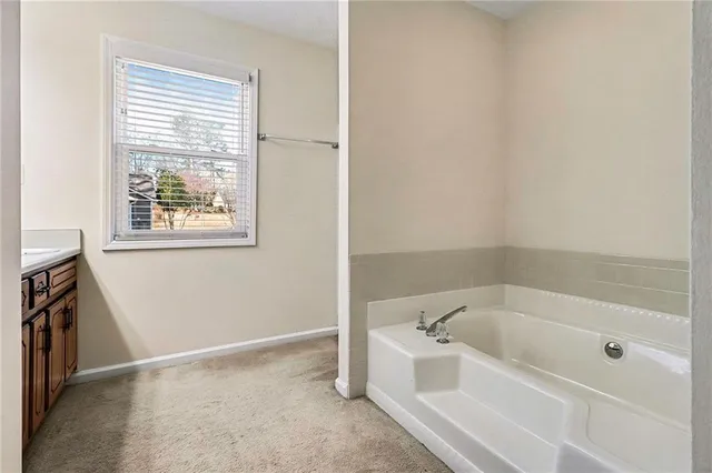 a white bath tub sitting next to a window