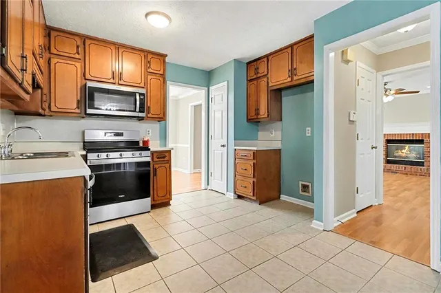 a kitchen with stainless steel appliances granite countertop a refrigerator stove and sink