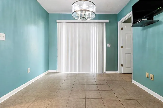 a view of a livingroom with an empty space and a window