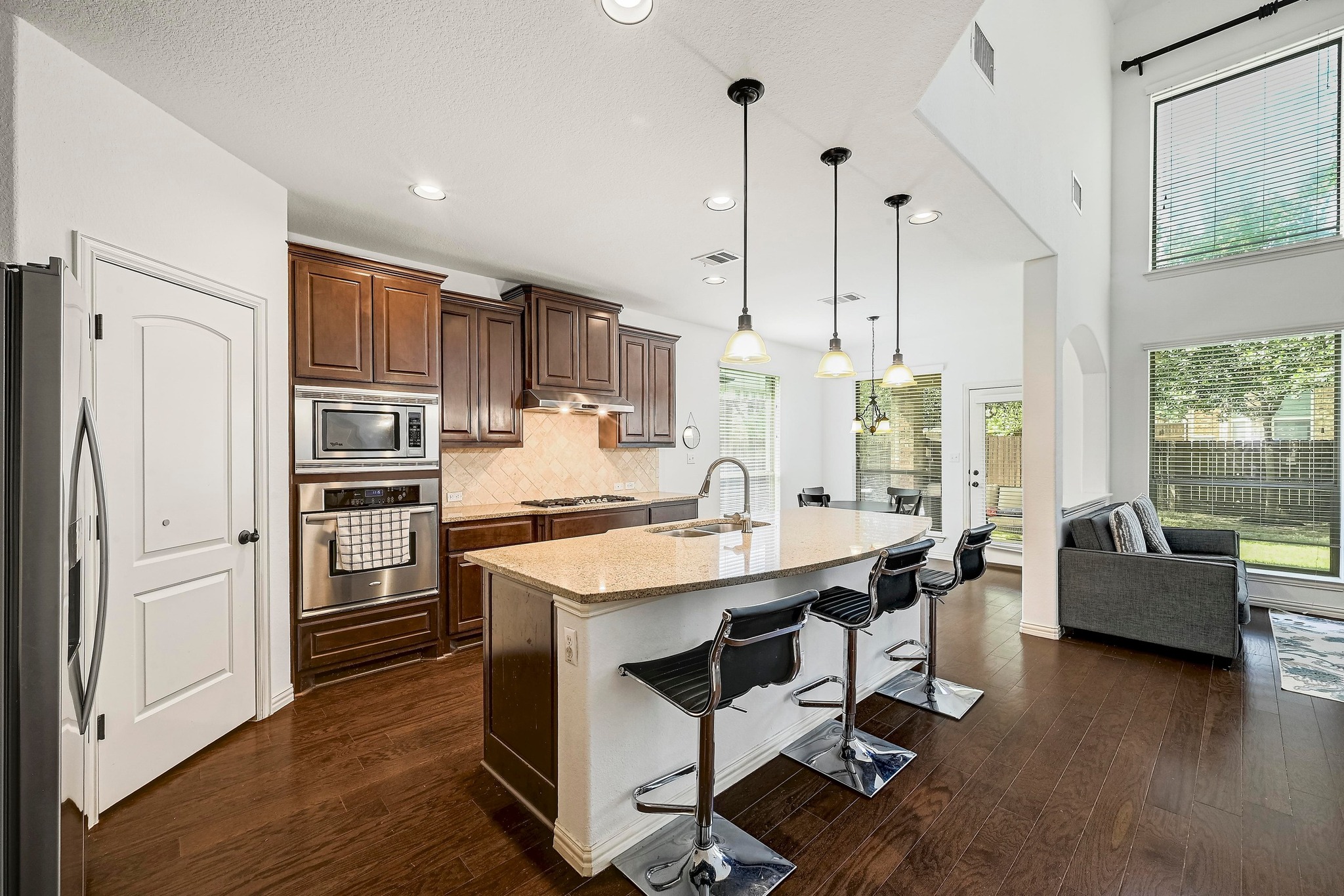 2229 Turtle Mountain Bend Austin, TX 78748 - Photo 10 of 38 a kitchen with kitchen island a large counter top space appliances and a chandelier