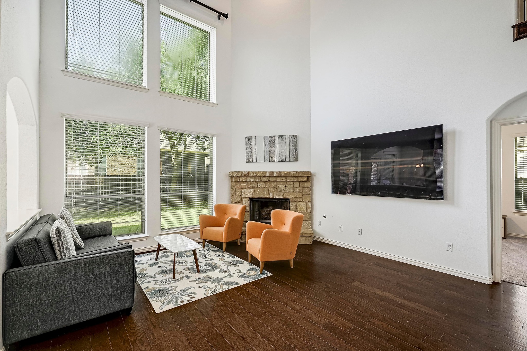 2229 Turtle Mountain Bend Austin, TX 78748 - Photo 7 of 38 a living room with furniture floor to ceiling window and a flat screen tv