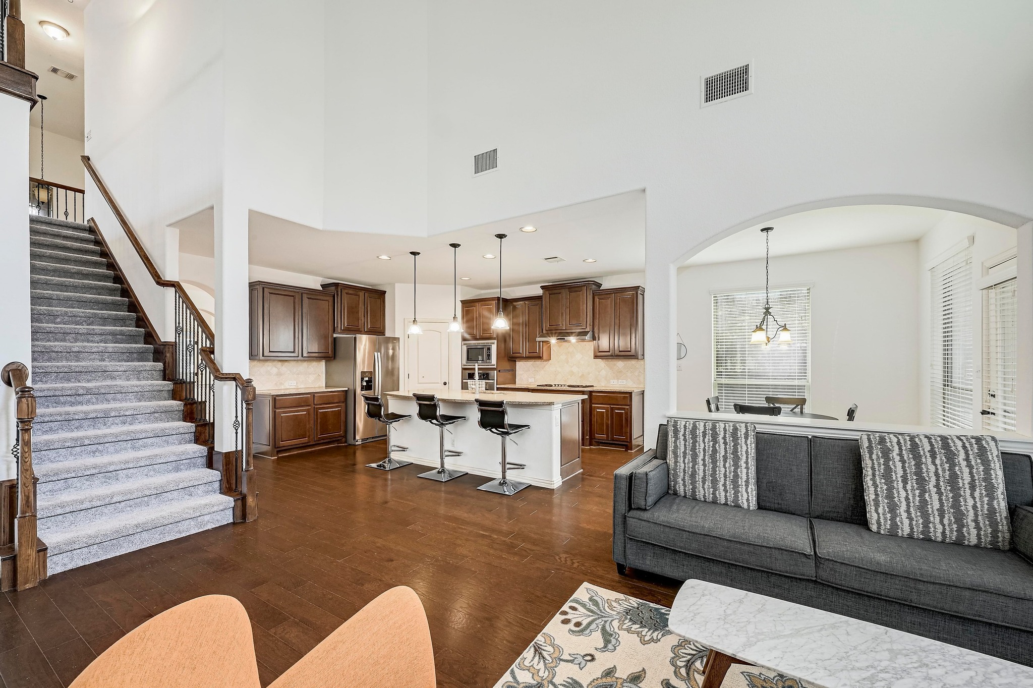 2229 Turtle Mountain Bend Austin, TX 78748 - Photo 9 of 38 a living room with furniture kitchen view and a wooden floor