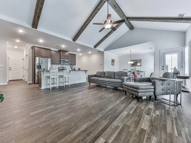a living room with furniture and kitchen view