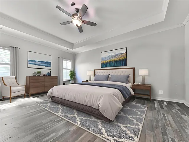 a spacious bedroom with a large bed a chandelier and windows