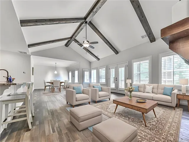 a living room with furniture and a ceiling fan