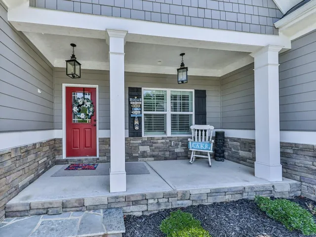 a view of an house with backyard and porch