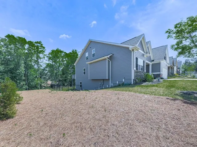 a view of a house with a yard and sitting area