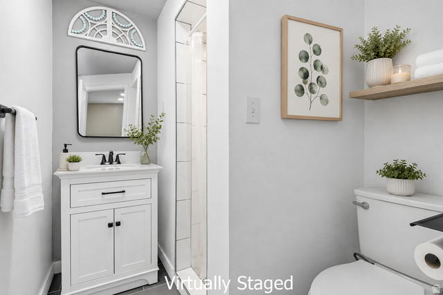 2693 Teal Way Sandy, UT 84093 - Photo 37 of 50 Bathroom featuring a white vanity with integrated sink, rectangular mirror, and dark hardware