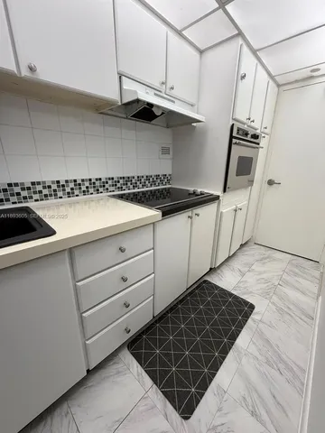 a kitchen with granite countertop a stove and a sink