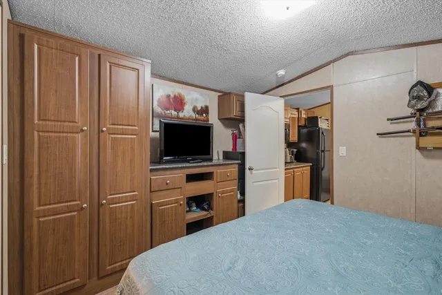 a bathroom with a granite countertop sink mirror vanity and toilet