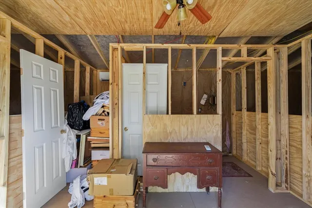 a view of a livingroom with furniture and a ceiling fan