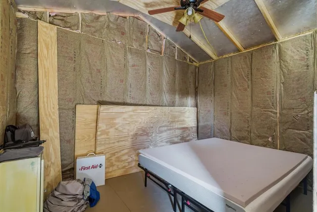 a view of a yard with wooden fence