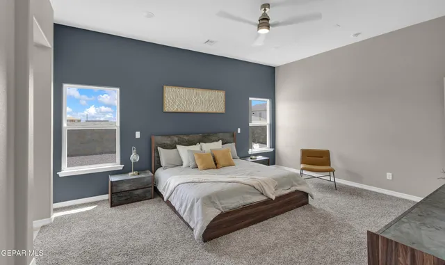 a spacious bedroom with a bed and cabinet