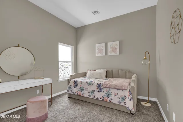 a bedroom with a bed and a window