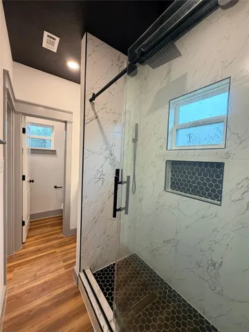 a bathroom with a granite countertop sink mirror and toilet