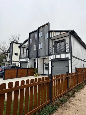 a front view of a house with wooden fence