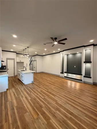 a view of a kitchen with kitchen island a sink stainless steel appliances and cabinets