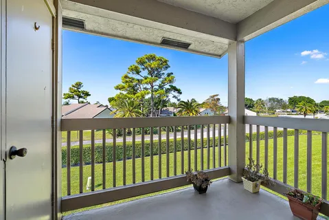 a view of a porch with a floor to ceiling window and stairs