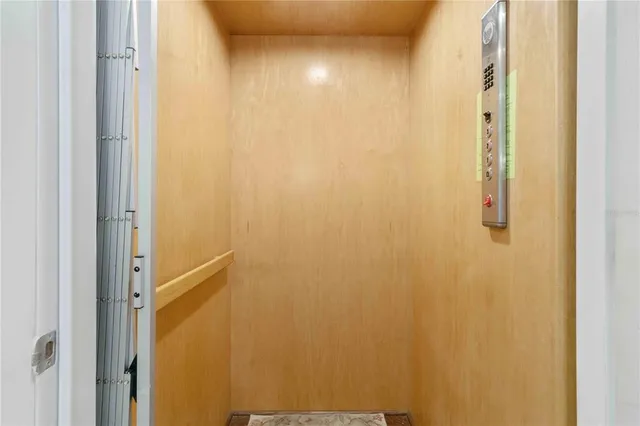 a living room with furniture a flat screen tv and a floor to ceiling window